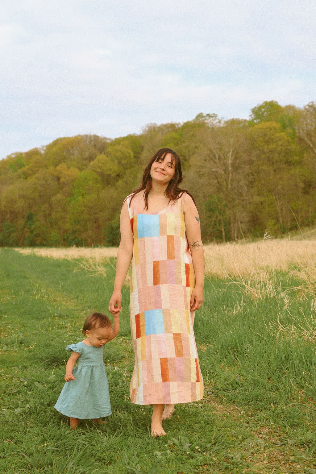 Jess, creator of The Covenant Co., standing in a green field